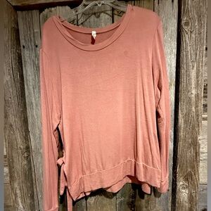 Blush pink long sleeve shirt ties on the side.